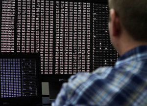 An analyst looks at code in the malware lab of a cyber security ...