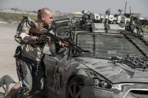 Military Powered Exoskeleton Behind a military vehicle