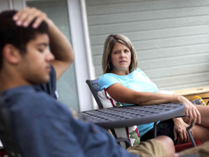 Amy Myers talks with her son Kamron, 18, in the backyard of their home ...