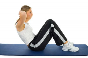 Young woman during exercising on a mat. Isolated on white background ...