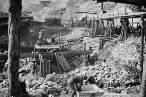Miners work a gold placer deposit in a Klondike mining camp.