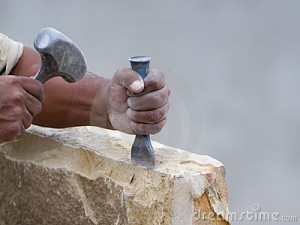 stone-mason-chiseling-a-block-of-stone