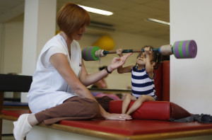 Luara Crystal, 5, who suffers from brittle bone disease, lifts a ...