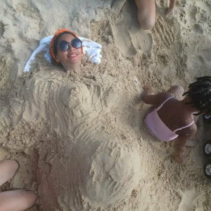 The photo shows Beyonce buried in sand without a baby bump made from ...