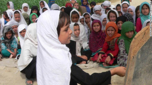 Afghan schoolgirls study in an open air school in Jalalabad. Violence ...
