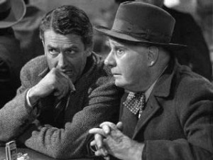 Picture of George Bailey whispering to Clarence at the bar