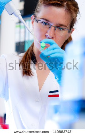 Serious female scientist takes aliquote from enzyme tube - stock photo