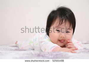 Cute Baby Infant Asian Girl with Tongue Sticking Out
