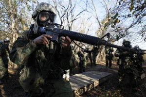 Army recruit practices securing the area during a chemical weapons ...