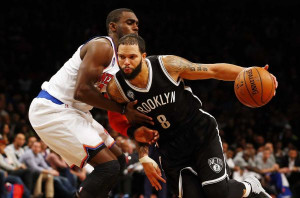 Deron Williams of the Nets drives to the hoop against Tim Hardaway Jr ...