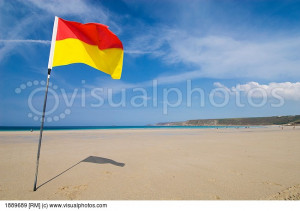 Yellow And Red Flag On The Beach At Sennen Cove