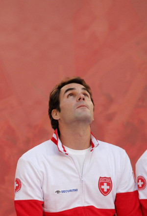 Switzerland's Roger Federer looks up as he attends the Davis Cup final ...