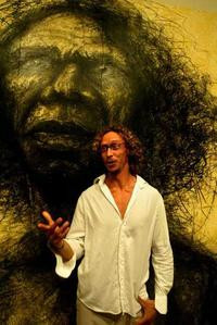 Craig Ruddy with his portrait of David Gulpilil.