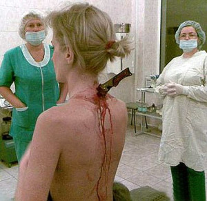 ... picture of mugging victim with a six-inch knife in her back is genuine