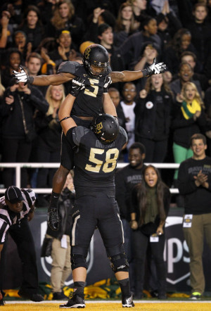Baylor wide receiver Antwan Goodley (5) is hoisted by offensive ...