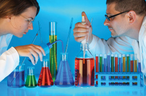 ... scientists mixing chemicals in test tubes and bottles in a laboratory