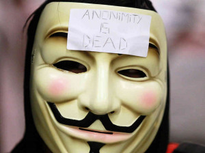 demonstrator wears a Guy Fawkes mask typically worn by followers of ...