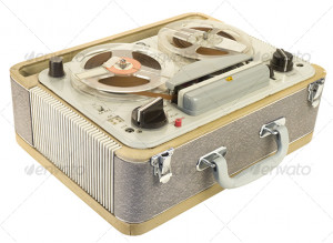 Tilt (3/4) view of an old portable reel to reel tape recorder. The ...