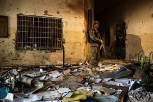 soldier stood guard amid the damage at the Army Public School in ...