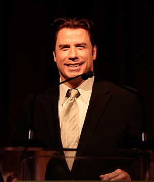 Actor JOHN TRAVOLTA, joking at a Hollywood event honoring women in the ...