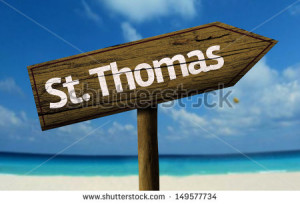 St. Thomas wooden sign with a beach on background - stock photo