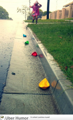 My daughter chasing paper boats in the rain.