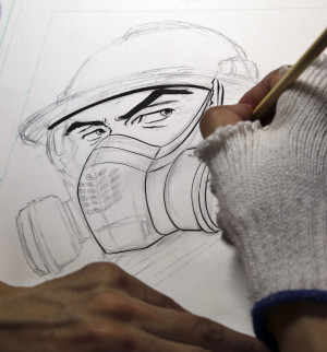 Comic-book artist Kazuto Tatsuta draws the main character in his comic ...