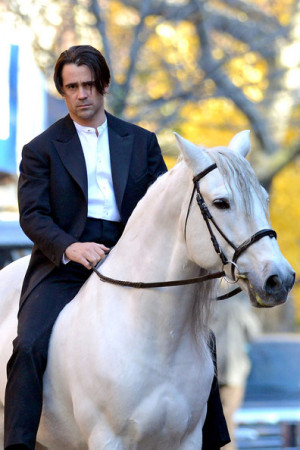 Colin Farrell rides a horse on the set of 