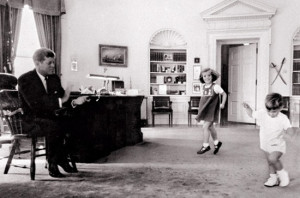 President John F. Kennedy clapping, as his children danced in the ...