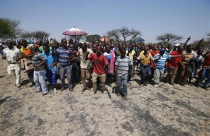 Striking platinum miners march near the Anglo-American Platinum ...