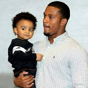 Courtesy of Steve Reddick Ameer Abdullah holds then-2-year-old D.J ...