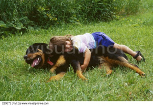 Two-year-old girl and pet Rottweiler