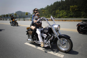 couple rides a Harley Davidson motorcycle during the annual Harley ...