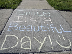 Chalking reads 'Smile, It's a Beautiful Day!'