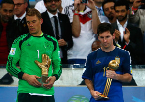 Glove trophy as Lionel Messi of Argentina holds the Golden Ball trophy ...
