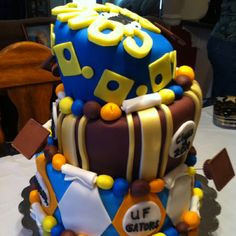 Nephew's graduation cake: topsy turvy with 3 tiers... Bottom = things ...