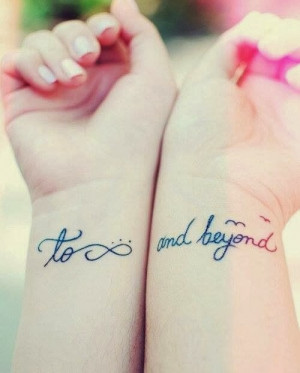 Quotes tattoos and infinity tattoos on wrist of girl