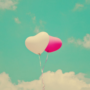 Two heart balloons on turquoise sky Art Print