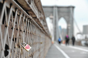... tourists have clipped hundreds of padlocks to the Brooklyn Bridge