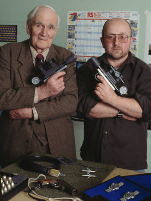 Desmond Llewelyn with special effects technician Nicholas Finlayson ...