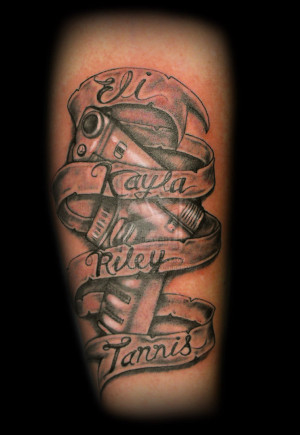 Grey Ink Banner And Gun Tattoo