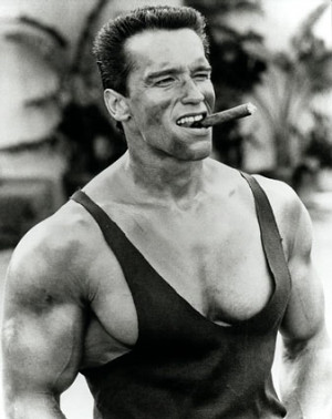 Arnold Schwarzenegger looking cool smoking a cigar
