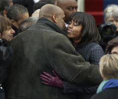 First lady Michelle Obama is greeted by her brother Craig Robinson at ...
