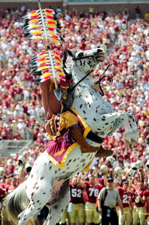 Chief Osceola mascot of the Florida State Seminoles plants a spear ...