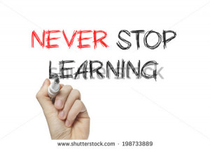 Hand writing never stop learning on a white board - stock photo