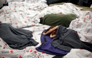 Unaccompanied children sleep in a holding cell at a U.S. Customs and ...