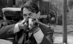Atticus Finch shoots mad dog with rifle.