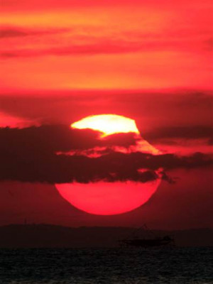 bite out of the setting sun. The moon casts a shadow on the upper ...
