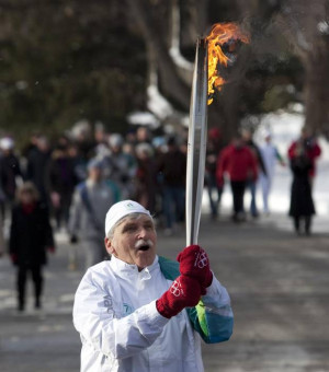 Romeo Dallaire carries the Olympic Flame towards Rideau Hall in Ottawa ...