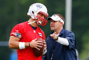 Tim Tebow talks with Patriots offensive coordinator Josh McDaniels at ...